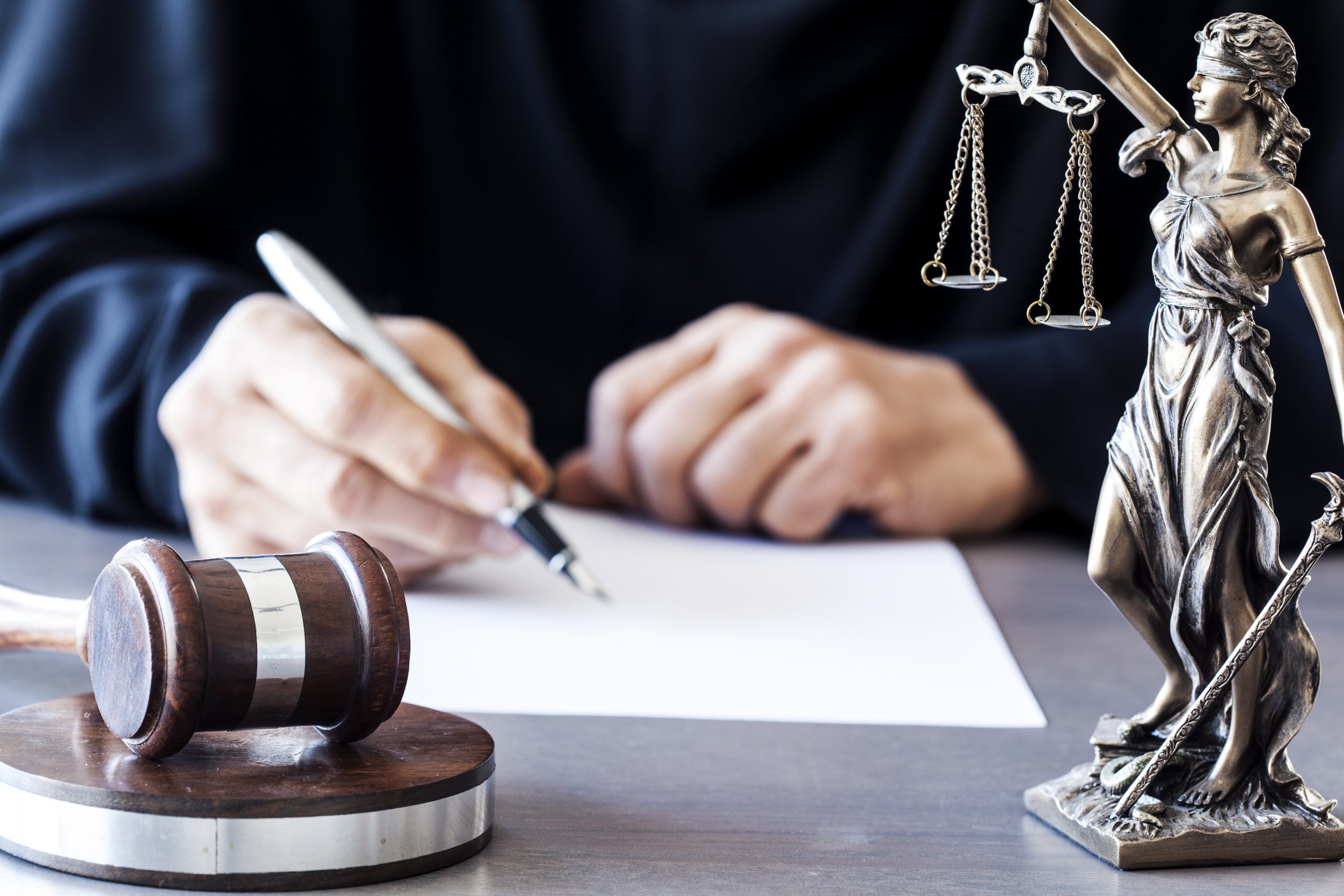 Judge with wooden gavel on table